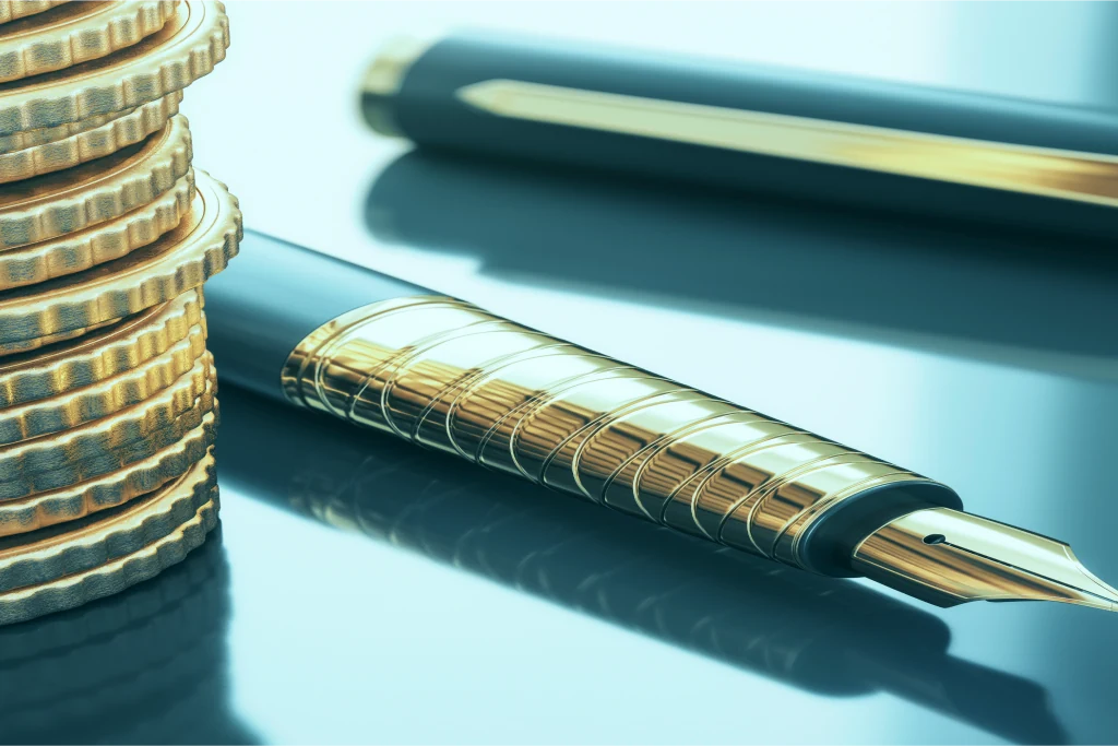 A fountain pen beside a stack of coins