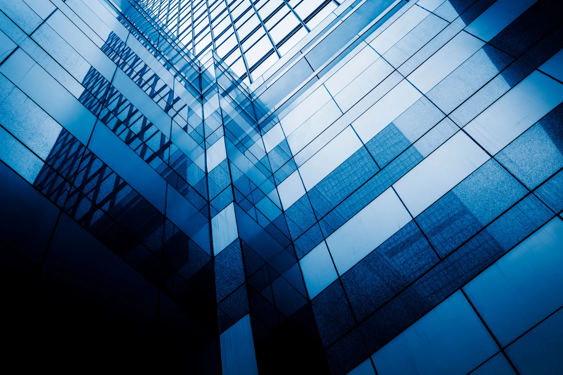 Glass office towers against a blue sky