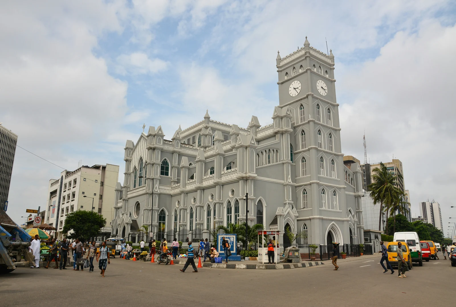 Historic clock-tower building overlooking a busy Lagos street