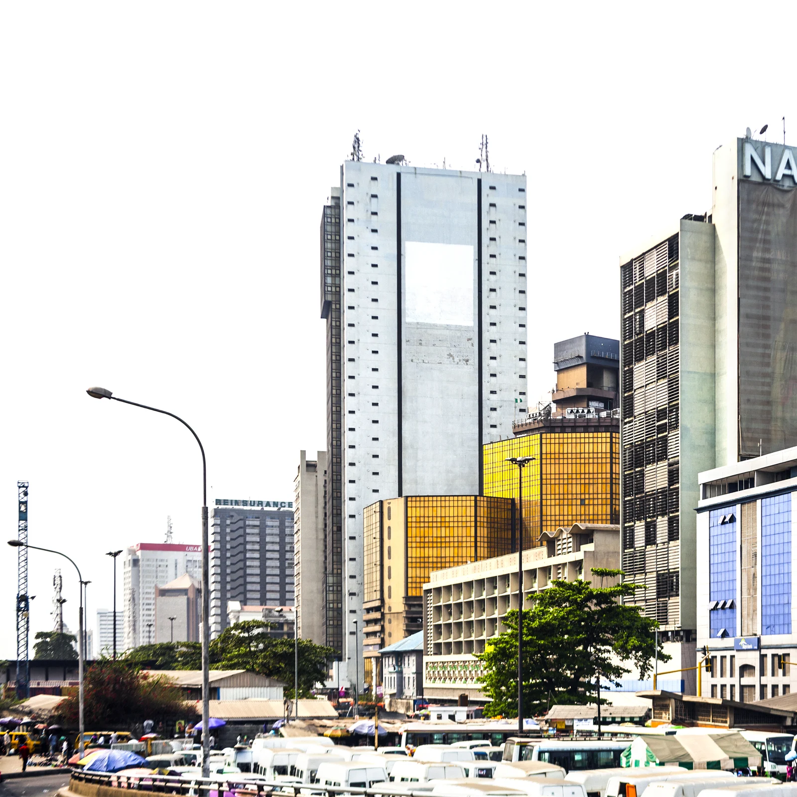 Boats along the waterfront beneath Lagos commercial buildings